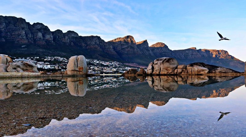 reflection off atlantic pool of Camps Bay and Tweleve Apostle flank of Table Mountain